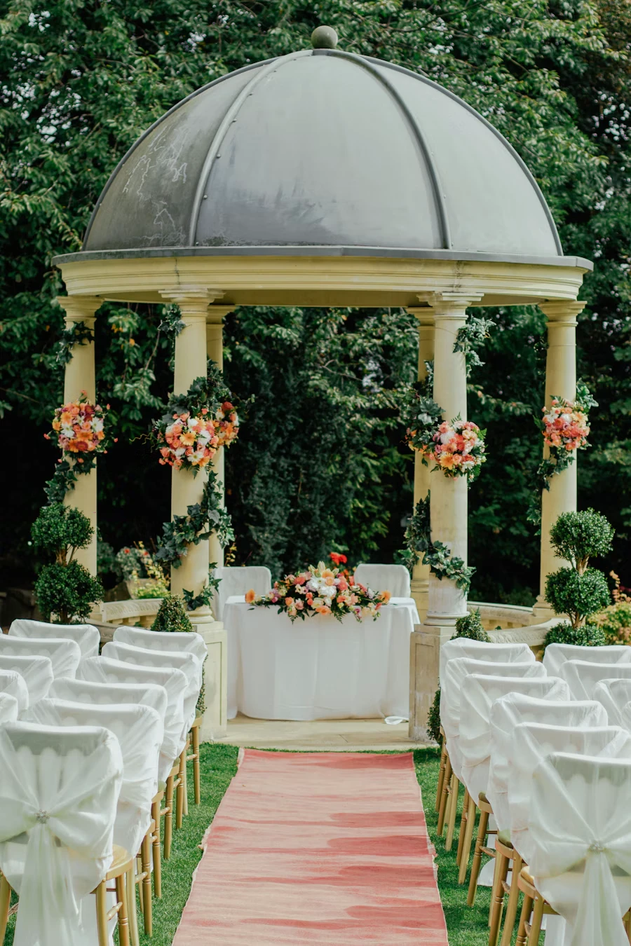 Wedding ceremony space decorated with greenery and flowers